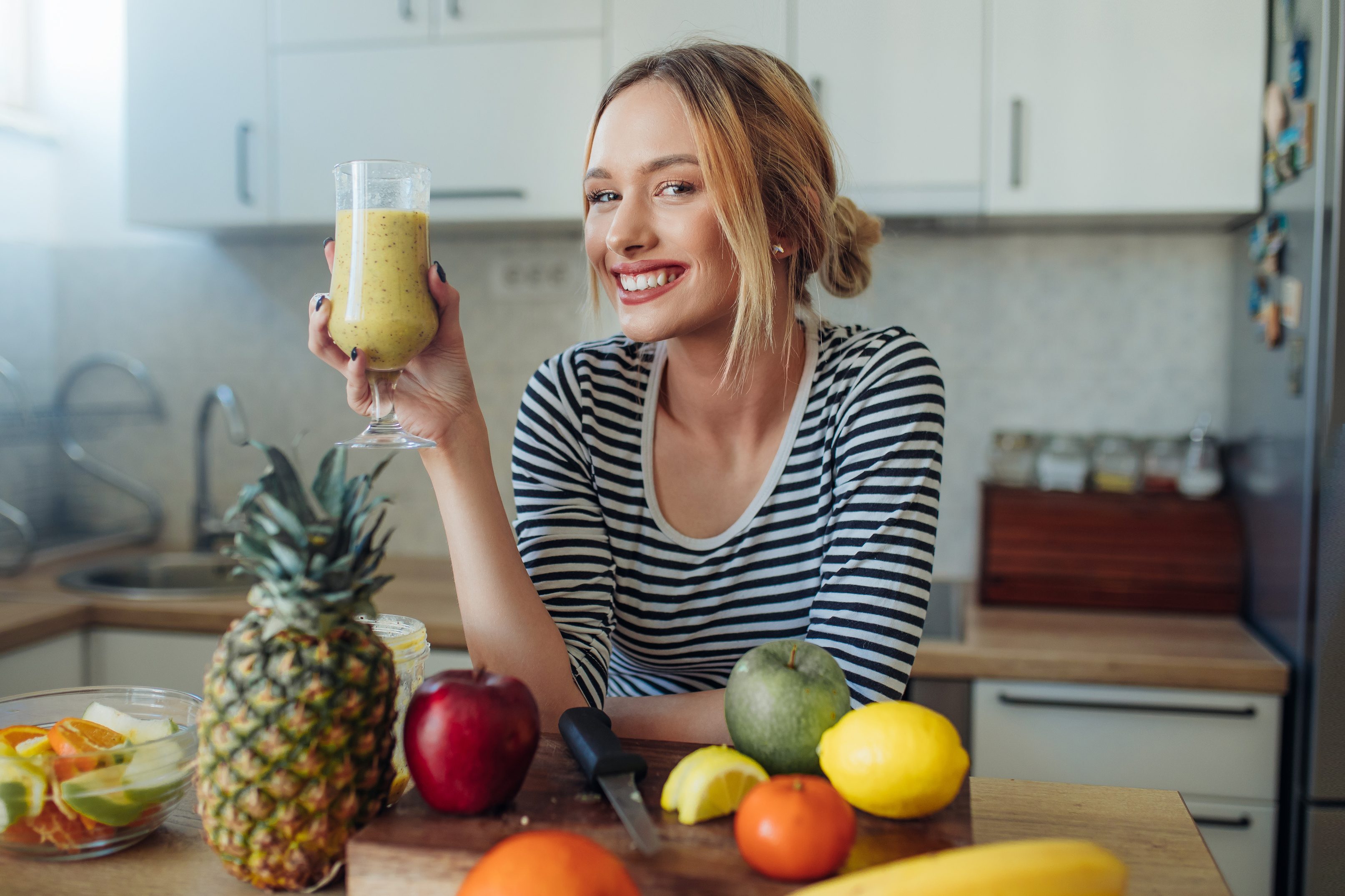 Happy smiling  healthy woman drinking smoothie